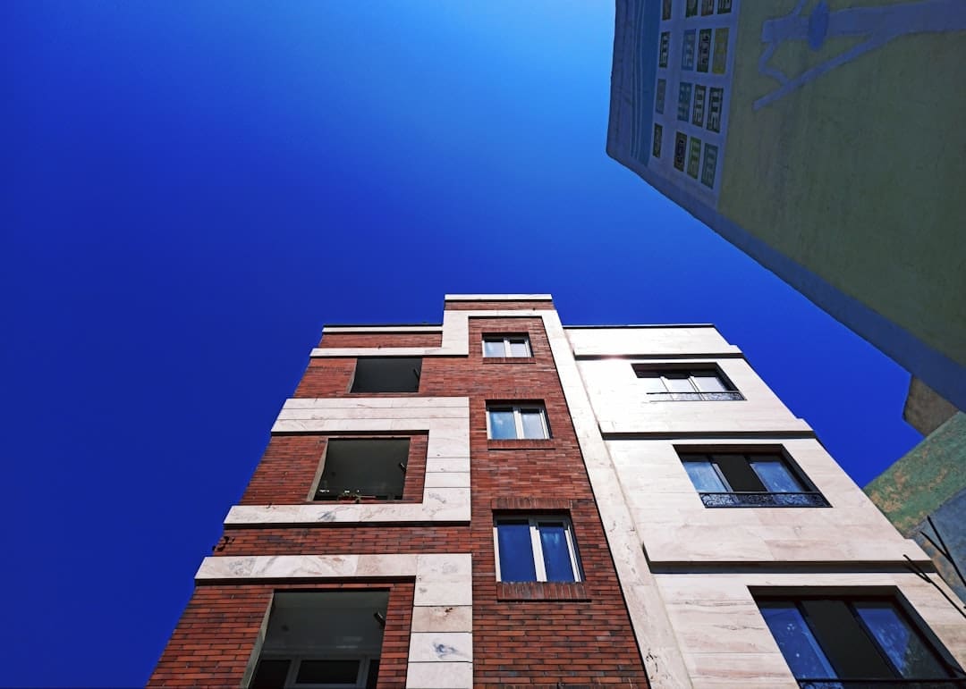 verify support animal letter — looking up at a tall brick building with windows