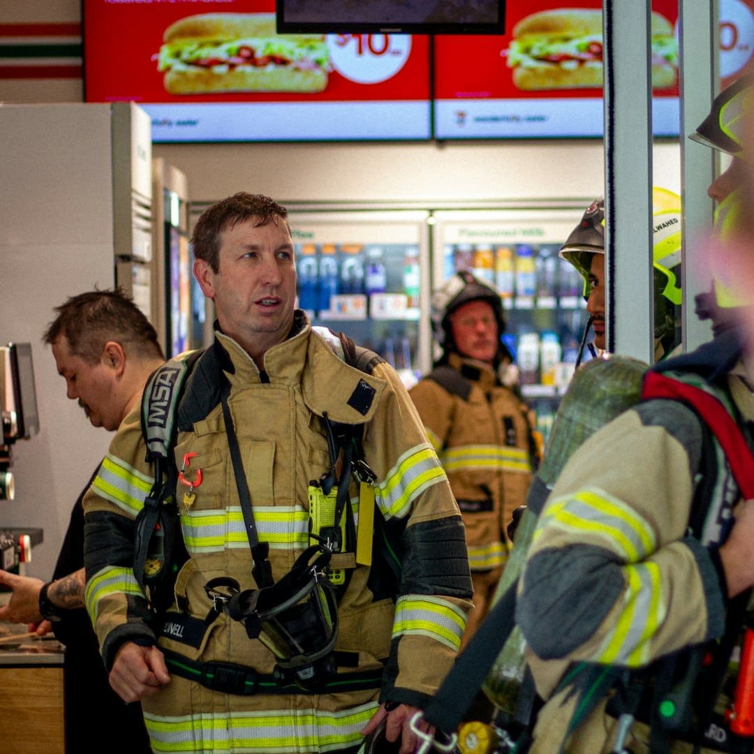 psychiatric service dog tasks — Firefighters in uniform inside a store