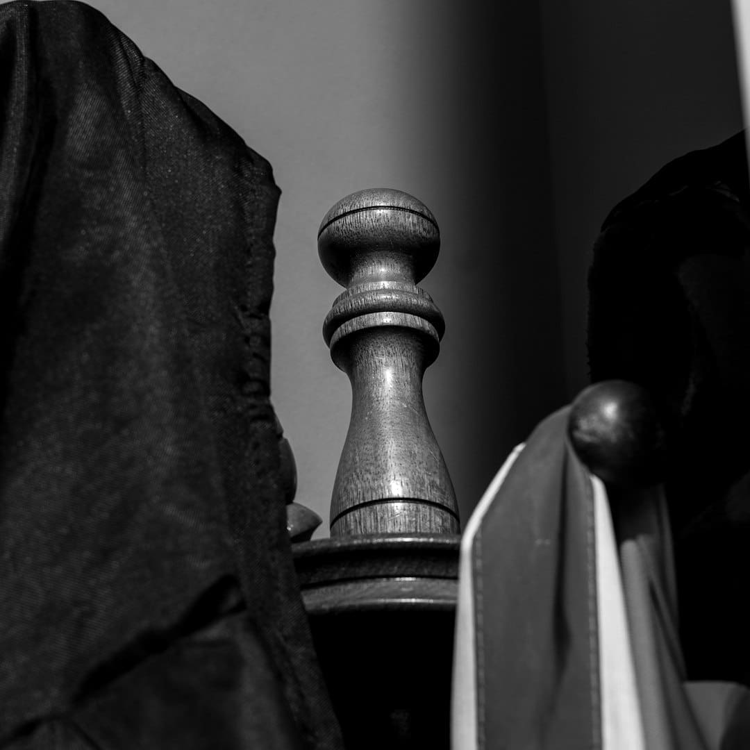 support animal laws — Close-up of a wooden finial between hanging clothes.